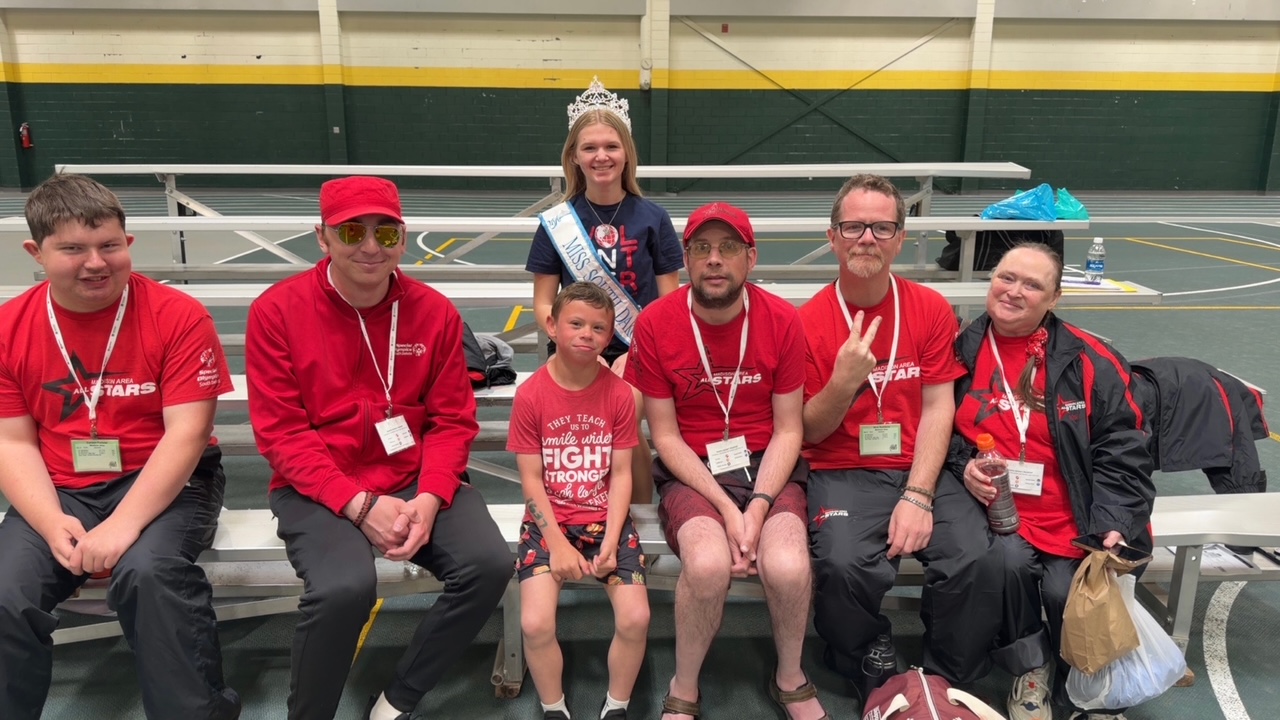Community members together on the bleachers at a sporting event