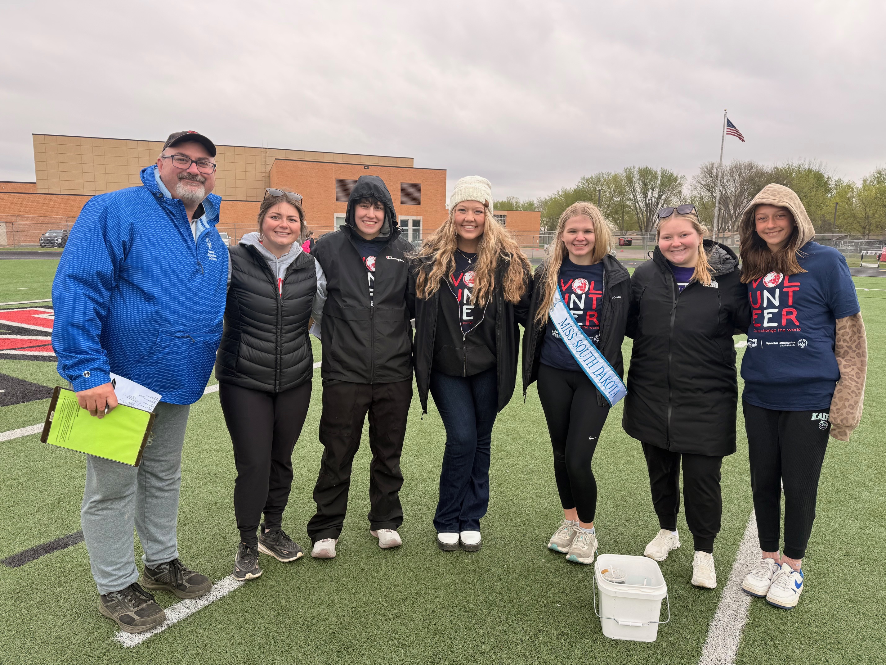 A group of community volunteers together at an outdoor track